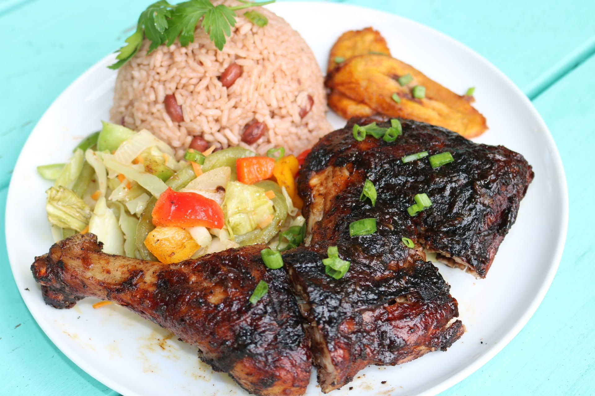 Jerk chicken with rice and peas, cabbage and fried plantain